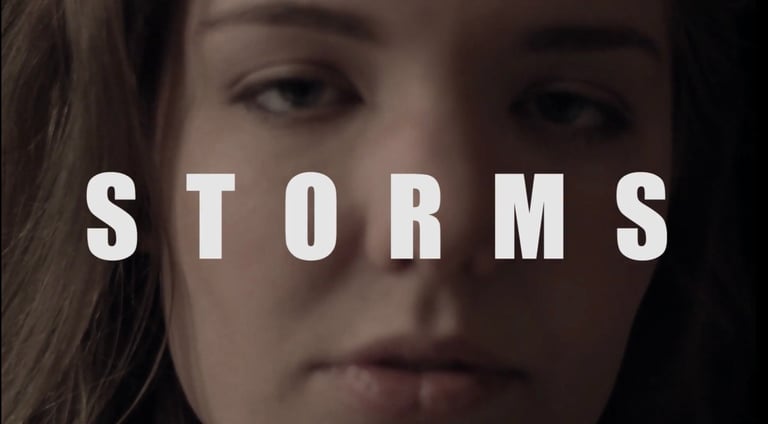 Close-up of a womans face with the word STORMS in large white text overlaid